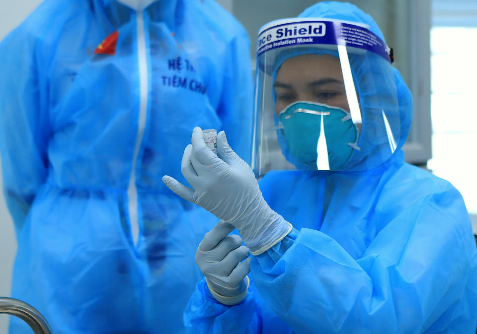 A health worker prepares a dose of AstraZeneca COVID-19 vaccine at Hospital for Tropical Diseases in Hanoi, Vietnam Monday, March 8, 2021. Vietnam has started the vaccination campaign with a hope to inoculate half of the population of 96 millions against COVID-19 by the end of the year. (AP Photo/Hau Dinh)