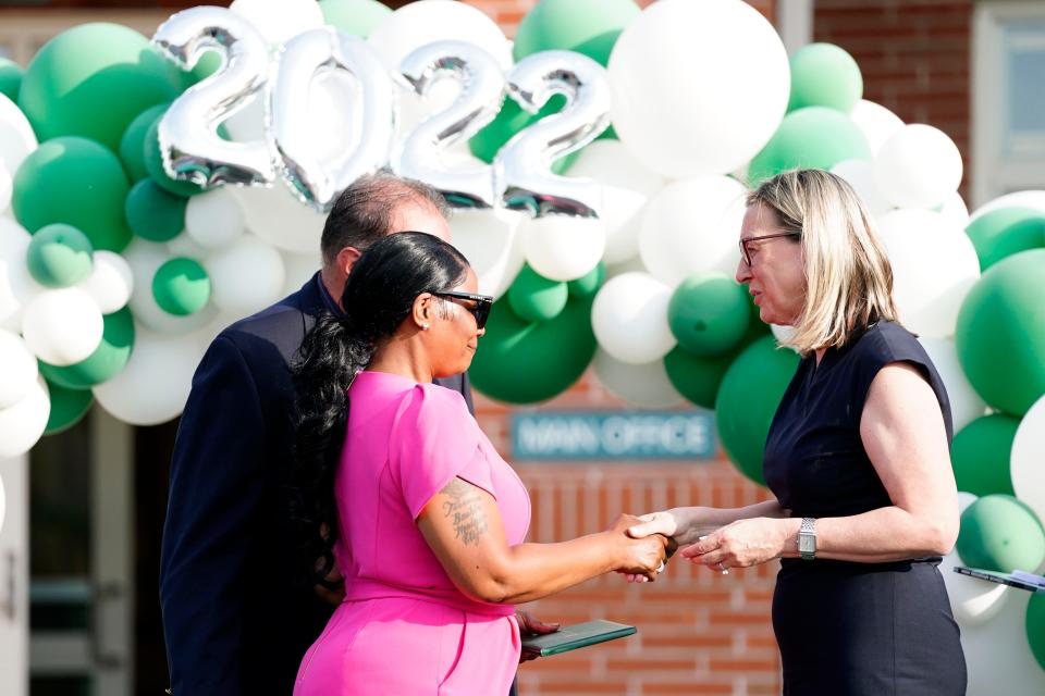 Latasha Reed, far left, accepts an honorary eighth grade diploma on behalf of her daughter, Monique Byrd, during the High Mountain School ceremony on Monday, June 20, 2022. Byrd, 15, was fatally shot by stray bullets in Paterson in May of this year. 