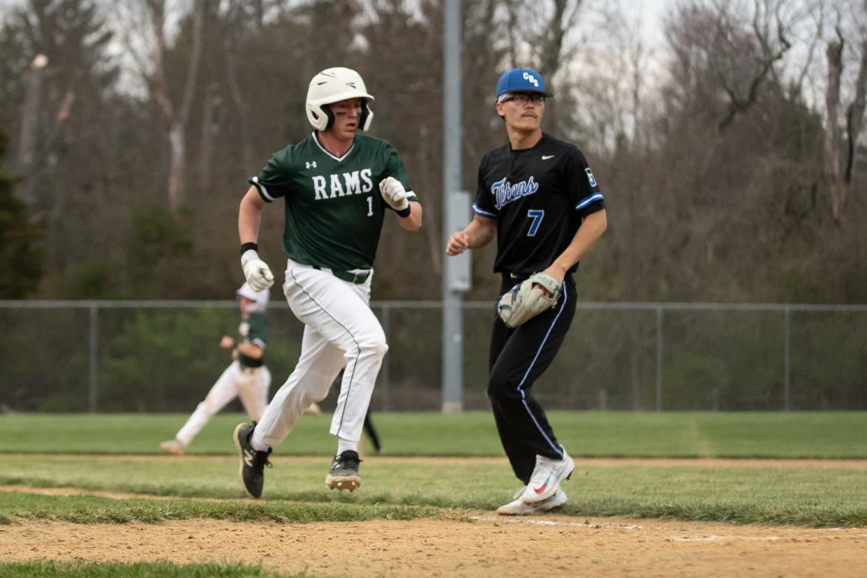 Pennridge's Andrew Rendler scores a run as Central Bucks South pitcher Michael Liu looks on during an April 9 game.