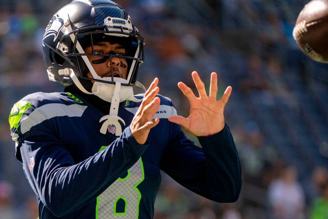 Seattle Seahawks cornerback Coby Bryant (8) catches a ball during warm ups prior to the start of an NFL game against the Atlanta Falcons on Sunday, Sept. 25, 2022, at Lumen Field in Seattle.