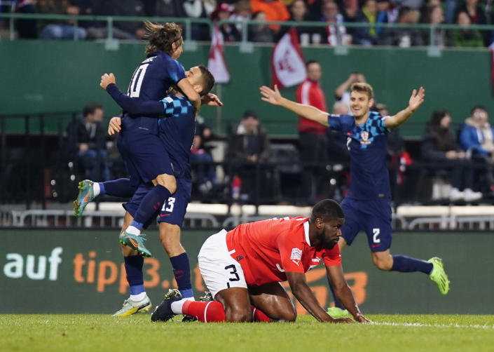 Austria's Kevin Danso, front, reacts after Croatia's Luka Modric scoring his side's opening goal during the UEFA Nations League soccer match between Austria and Croatia at the Ernst Happel Stadion in Vienna, Austria, Sunday, Sept. 25, 2022. (AP Photo/Florian Schroetter)