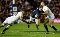 Rugby Union - Scotland v England - RBS Six Nations Championship 2016 - Murrayfield Stadium, Edinburgh, Scotland - 6/2/16 Scotland’s Stuart Hogg tackled by England’s Courtney Lawes and Mike Brown Reuters / Russell Cheyne Livepic