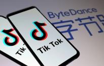 FILE PHOTO: Tik Tok logos are seen on smartphones in front of displayed ByteDance logo in this illustration