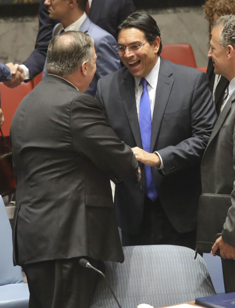 United States Secretary of State Michael Pompeo, left, and Israel United Nations Ambassador Danny Danon, center, shake hands before a meeting of the U.N. Security Council on the Mideast, Tuesday Aug. 20, 2019 at U.N. headquarters. (AP Photo/Bebeto Matthews)