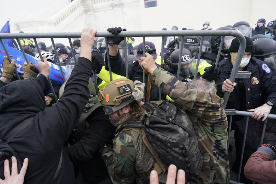 Police try to hold back protesters attempting to halt a joint session of the 117th Congress in Washington on Jan. 6. (Photo: Kent Nishimura via Getty Images)