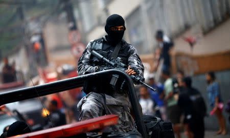 A policeman patrols the Pavao-Pavaozinho slum after a shootout during a police operation in Rio de Janeiro, Brazil, October 10, 2016. REUTERS/Ricardo Moraes