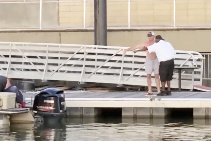 Two men discuss the location of a boat at the Montgomery Riverfront, Alabama, on Aug. 5, 2023. (Courtesy Christa Owen)