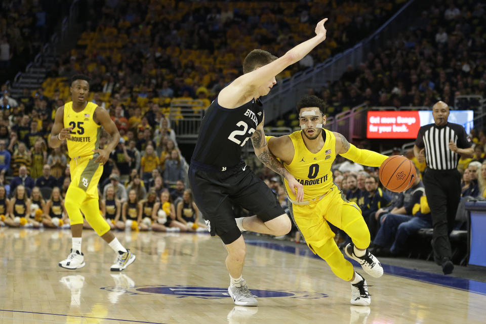 Marquette's Markus Howard (0) drives to the basket against Butler's Sean McDermott (22) during the first half of an NCAA college basketball game Sunday, Feb. 9, 2020, in Milwaukee. (AP Photo/Aaron Gash)