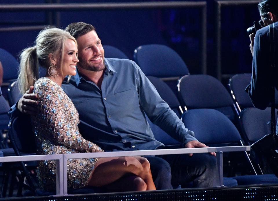 Carrie Underwood and Mike Fisher pose for a photo before the 2019 CMT Music Awards at Bridgestone Arena in Nashville, Tenn.