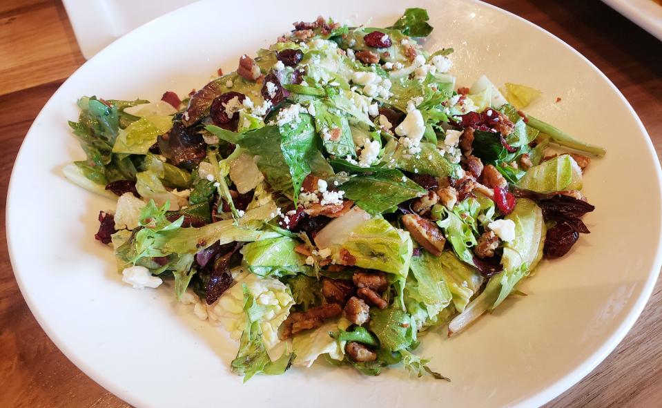 The Gorgonberry Pecan salad is one of the options on the Bru Burger Bar menu. The salad is made with mixed greens, cranberry-poppyseed dressing, Gorgonzola cheese, cranberries, candied pecans and bacon.