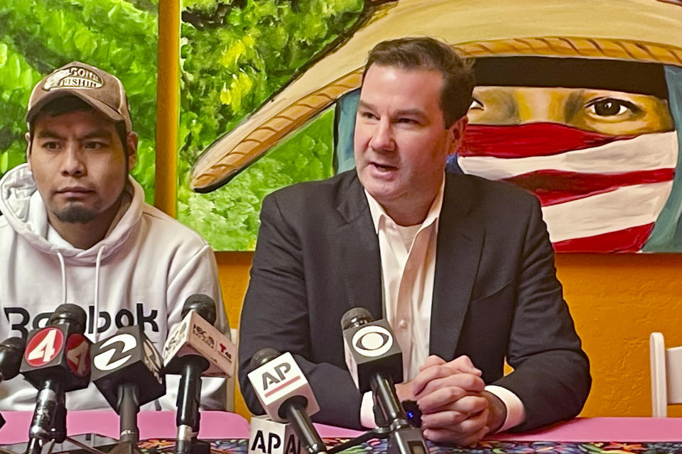 Attorney Donald Magilligan, right, talks next to his client Pedro Romero Perez during a press conference Friday, April 5, 2024, in Half Moon Bay, Calif. Perez, a migrant farmworker who survived a mass shooting at a Northern California mushroom farm, filed a lawsuit Friday against the farm owner, saying he failed to keep him safe from a co-worker who last year shot and killed his brother and three other co-workers before driving to another mushroom farm and killing three former colleagues. (AP Photo/Haven Daley)