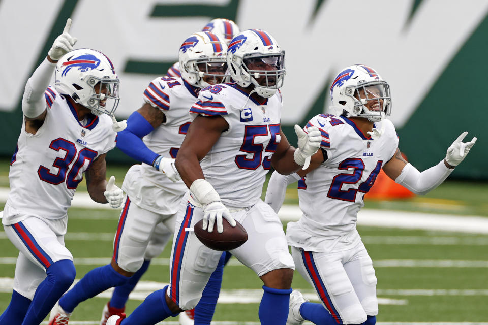 FILE - In this Oct. 25, 2020, file photo, Buffalo Bills defensive end Jerry Hughes (55) celebrates with teammates after an interception during an NFL football game against the New York Jets in East Rutherford, N.J. If this is the end of the line for Jerry Hughes’ career, the Buffalo Bills defensive end is primed for the playoffs. Whether it’s facing the arch-rival New England Patriots for a third time in seven weeks or the prospect of playing in potentially sub-0 temperatures on Saturday night, the 12th-year player is taking both head on. (AP Photo/Adam Hunger, File)