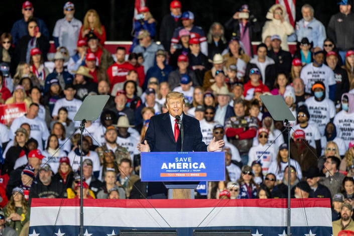 Former President Donald Trump speaks onstage at a rally.