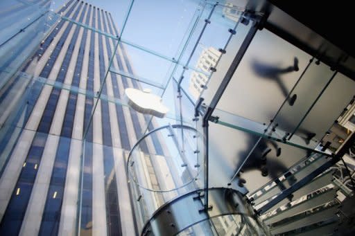 Customers walk through the Apple Fifth Avenue flagship store on the first morning the iPhone 5 went on sale in New York City