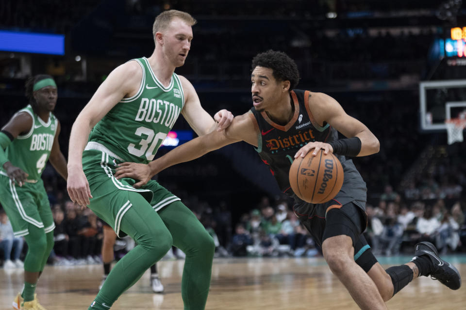 Washington Wizards guard Jordan Poole, right, drives as Boston Celtics forward Sam Hauser (30) defends during the first half of an NBA basketball game in Washington, Sunday, March 17, 2024. (AP Photo/Manuel Balce Ceneta)