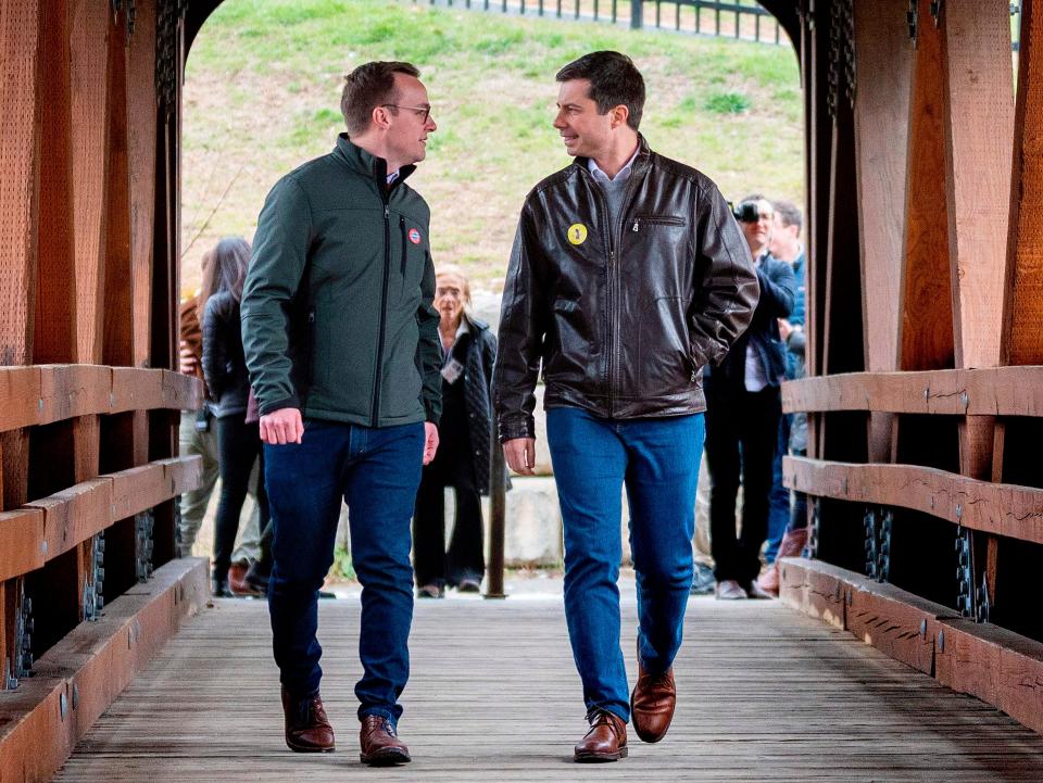 pete and chasten buttigieg walking down bridge