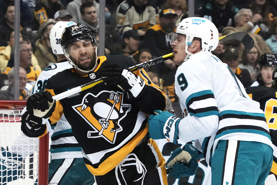 Pittsburgh Penguins' Jason Zucker (16) collides with San Jose Sharks' Jacob MacDonald during the second period of an NHL hockey game in Pittsburgh, Saturday, Jan. 28, 2023. (AP Photo/Gene J. Puskar)