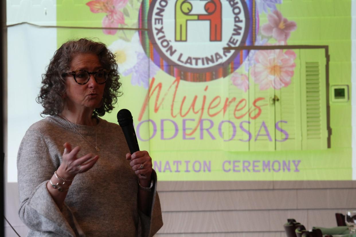 Conexión Latina Newport co-founder Rebekah Gomez addresses a group of women who have gone through the organization's first women's empowerment program, Mujeres Poderosas.