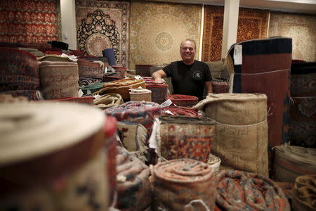 Alex Helmi, 59, owner of Damoka carpet store, which he has owned for 26 years, stands amongst his Persian carpets in Westwood, Los Angeles, California, United States July 14, 2015. REUTERS/Lucy Nicholson