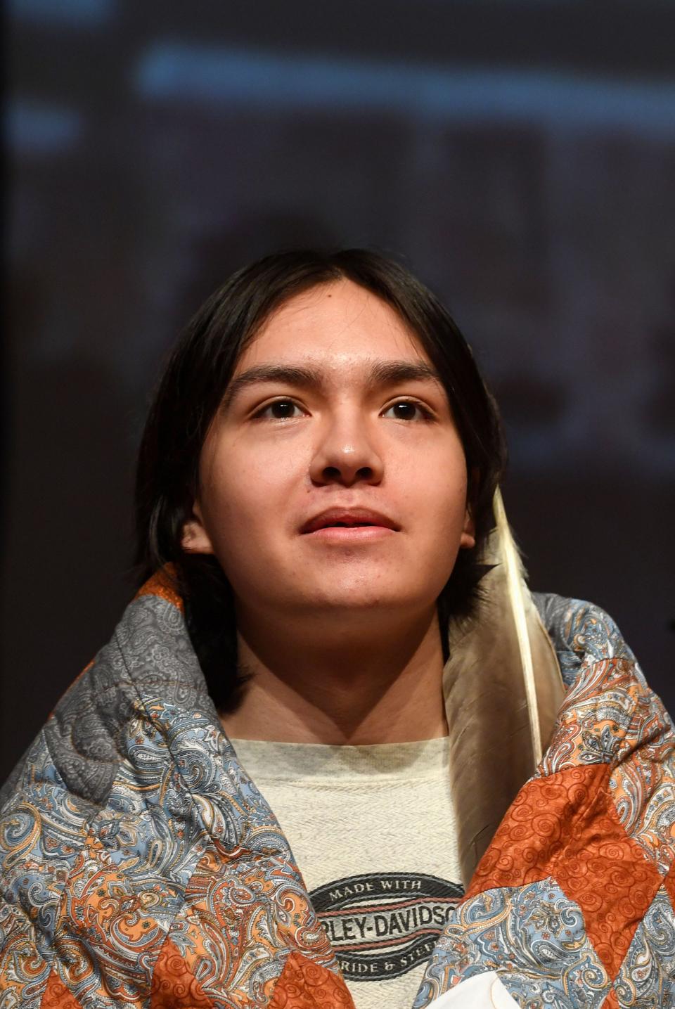 Native American students stand with eagle feathers and quilts given to them at a celebration for graduating from Sioux Falls public schools on Friday, May 27, 2022, at Washington High School.