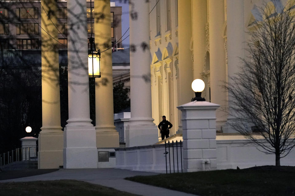 A U.S. Secret Service guard stands post at the North Portico of the White House, after the U.S. House impeached President Donald Trump in Washington, Wednesday, Jan. 13, 2021. (AP Photo/Gerald Herbert )