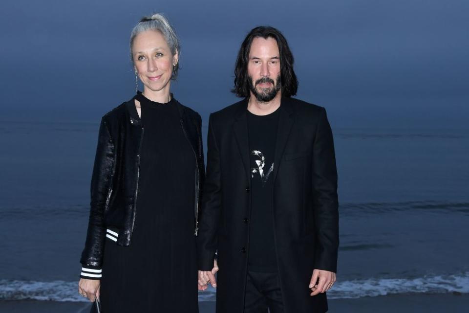 Alexandra Grant and Keanu Reeves hold hands at a June 2016 event. (Photo: Valerie Macon/AFP) 