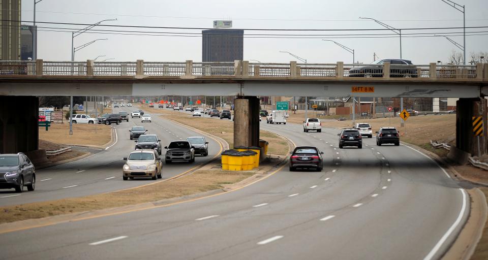 Vehicles travel under a May Avenue bridge along Northwest Expressway on Jan. 17, 2023.