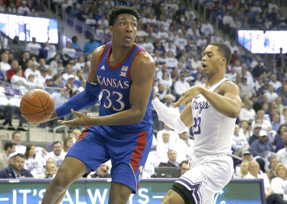 Kansas forward David McCormack (33) looks to pass as TCU forward Jaedon LeDee (23) defends during the first half of an NCAA college basketball game, Saturday, Feb. 8, 2020, in Fort Worth, Texas. (AP Photo/Ron Jenkins)