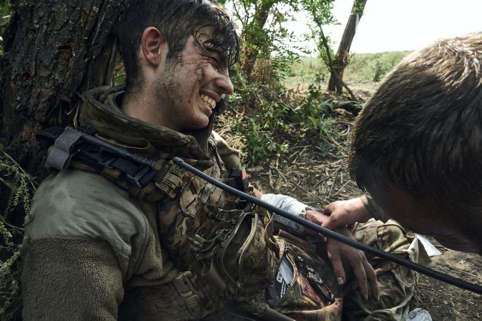 A soldier of Ukraine's 3rd Separate Assault Brigade gives first aid to his 19-year-old wounded comrade near Bakhmut, the site of fierce battles with the Russian forces in the Donetsk region, Ukraine, on Monday, Sept. 4, 2023.