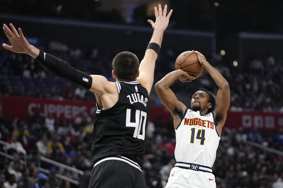 Denver Nuggets guard Ish Smith, right, shoots as Los Angeles Clippers center Ivica Zubac defends during the second half of an NBA basketball game Friday, Nov. 25, 2022, in Los Angeles. (AP Photo/Mark J. Terrill)