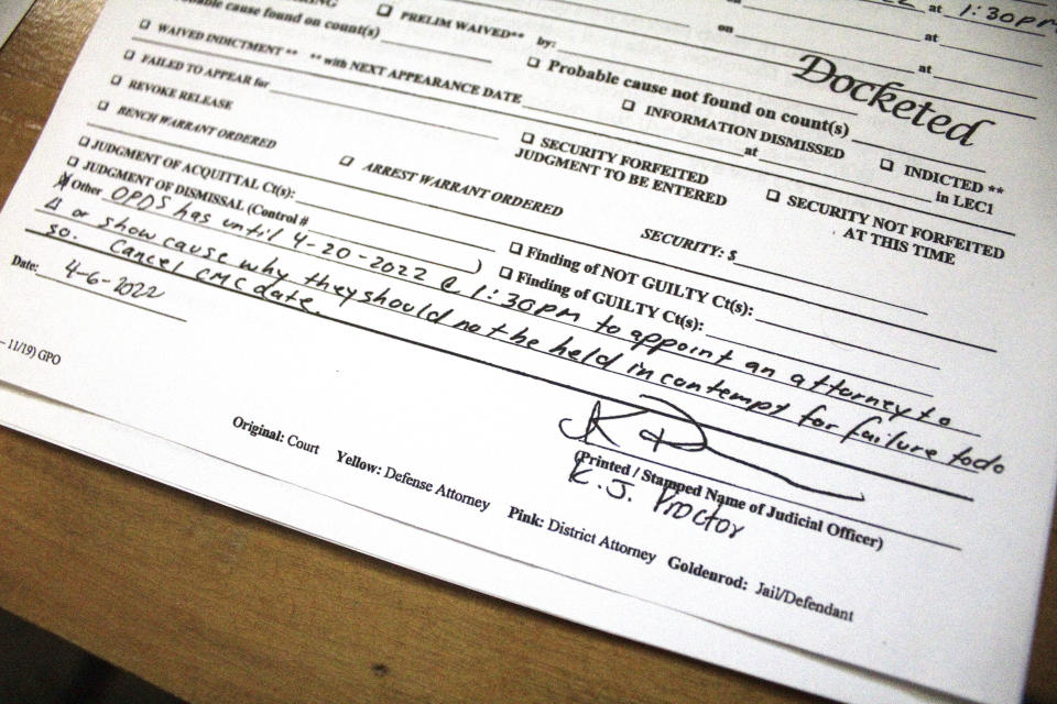 Courtroom notes showing that a Washington County, Ore., judge threatened to hold Oregon Public Defense Services in contempt of court for not providing a public defender to a criminal defendant are seen in this May 4, 2022, photo. The defendant in this case is charged with rape, sodomy and other sexual crimes and was finally assigned a public defender this week after weeks without one, prompting the judge's action. A post-pandemic glut of delayed cases has exposed shocking constitutional landmines impacting defendants and crime victims alike in Oregon, where an acute shortage of public defenders has even led judges to dismiss serious cases. (AP Photo/Gillian Flaccus)