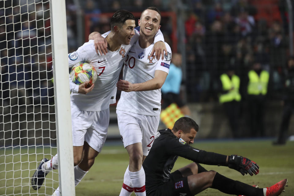 Portugal's Cristiano Ronaldo, left, celebrates with his teammate Diogo Jota after he scored his side's second goal during the Euro 2020 group B qualifying soccer match between Luxembourg and Portugal at the Josy Barthel stadium in Luxembourg, Sunday, Nov. 17, 2019. (AP Photo/Francisco Seco)