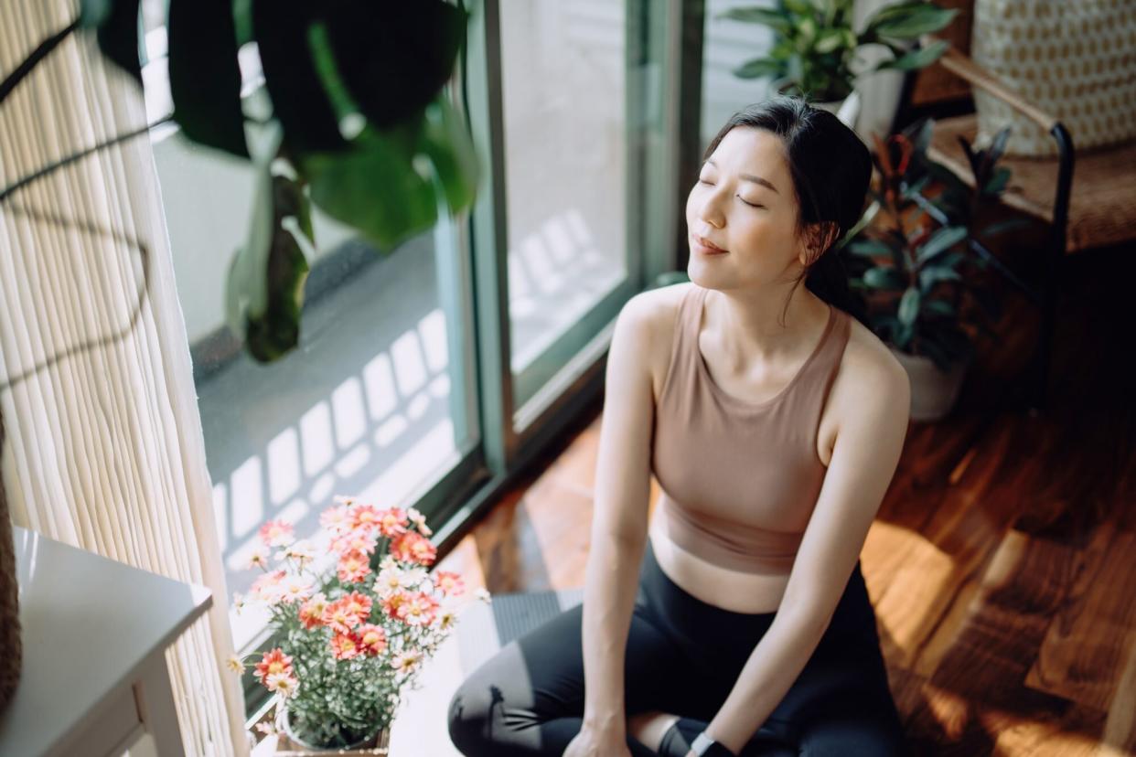 Woman trying breathing techniques. (Getty Images)