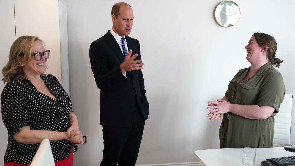 Prince William with two members of staff 