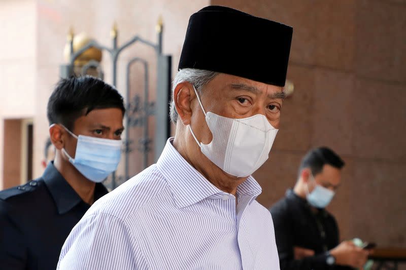 FILE PHOTO: FILE PHOTO: Malaysia's Prime Minister Muhyiddin Yassin wearing a protective mask arrives at a mosque for prayers, amid the coronavirus disease (COVID-19) outbreak in Putrajaya