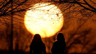 People watching the sunset at a park.