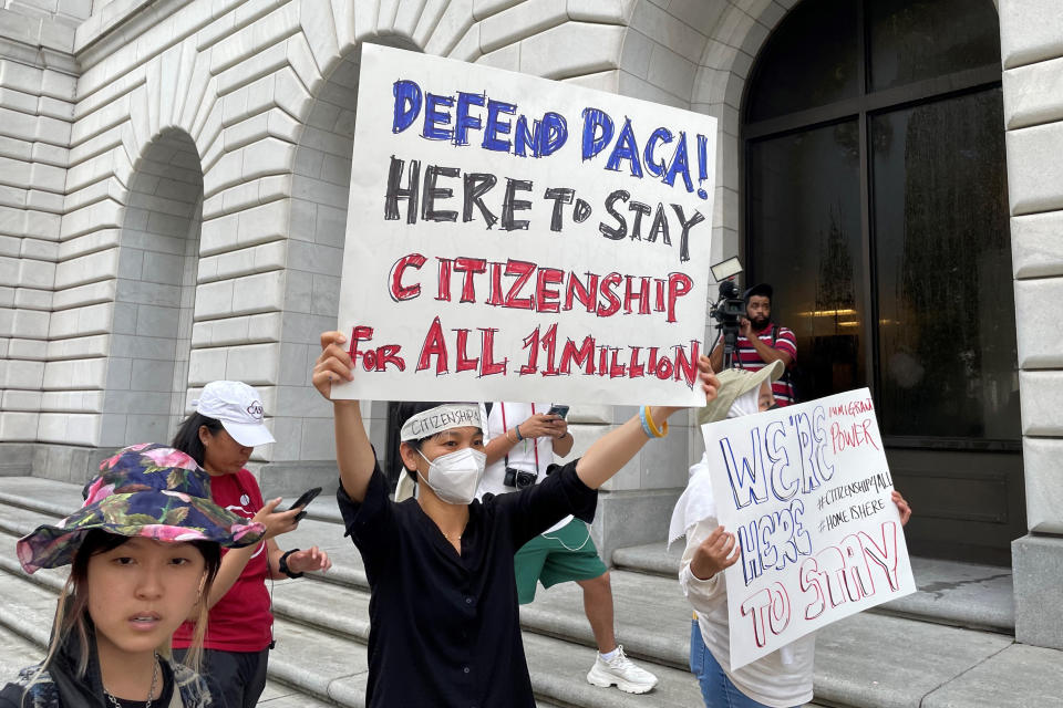 Demonstrators hold up signs outside the 5th U.S. Circuit Court of Appeals building in New Orleans on Wednesday, July 6, 2022. A panel of 5th Circuit judges heard arguments on an Obama-era program that prevents the deportation of thousands of immigrants brought into the United States as children. A federal judge in Texas last year declared the Deferred Action for Childhood Arrivals program illegal — although he agreed to leave the program intact for those already benefiting from it while his order is appeal. (AP Photo/Kevin McGill)