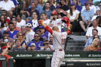 Cincinnati Reds' Joey Votto gestures while returning to the dugout after hitting a home run against the Chicago Cubs during the third inning of a baseball game Tuesday, July 27, 2021, in Chicago. (AP Photo/David Banks)