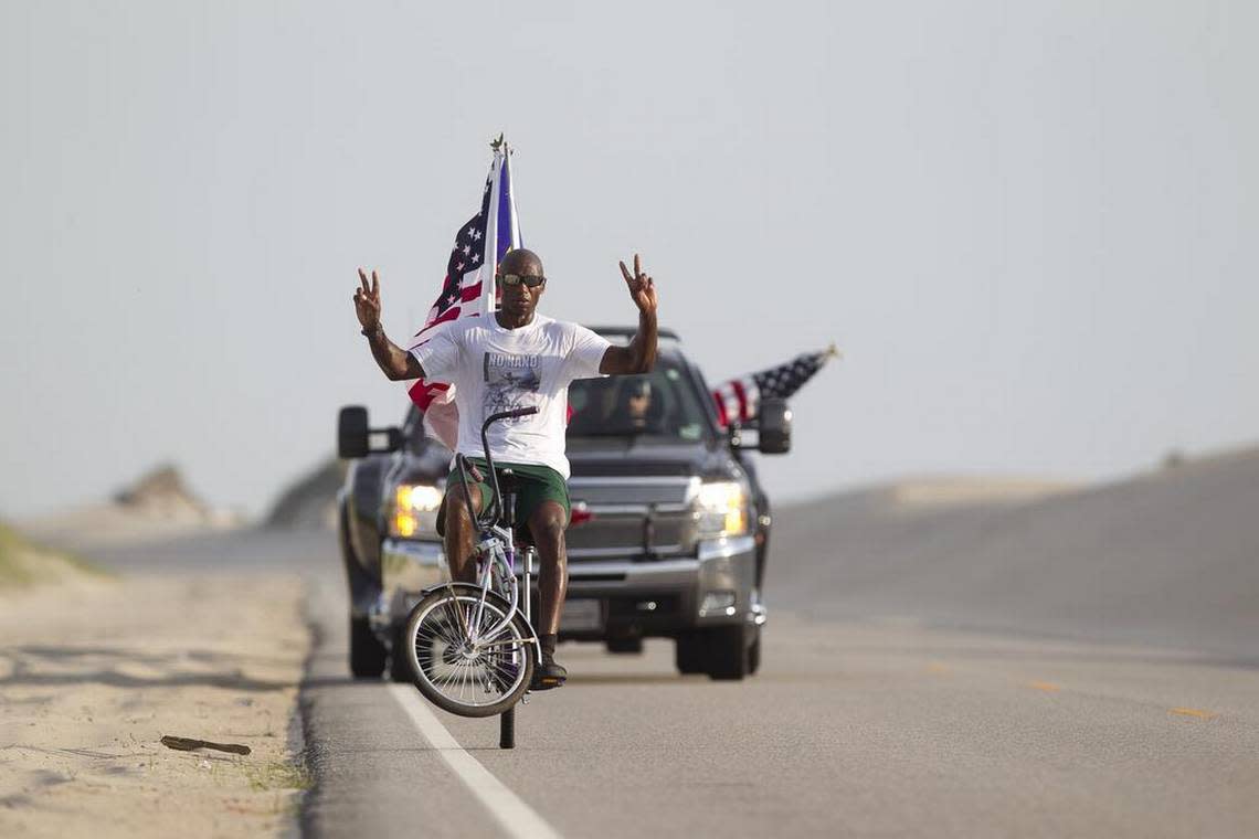 Rodney Hines of Raleigh, N.C, the “ No-Hand King” pedals on one wheel along NC 12 between sand dunes in the Pea Island Wildlife Refuge on Tuesday June 16, 2015 in the Cape Hatteras National Seashore on the North Carolina Outer Banks. Hines was attempting to ride on one wheel from Nags Head to Buxton. After a fall, and several episodes of cramping, Hines stopped his ride after approximately 31 miles. Robert Willett / rwillett@newsobserver.com
