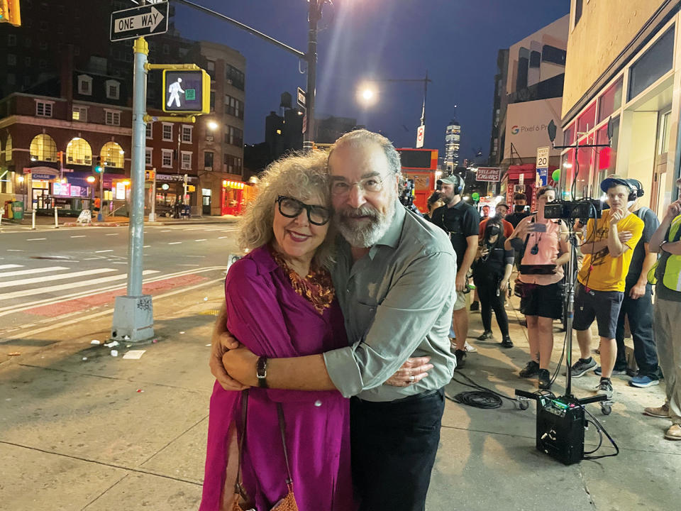Kathryn Grody and Mandy Patinkin hugging on a New York street film set