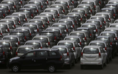 FILE PHOTO: Cars are parked to prepare for export at a port in Yokohama, south of Tokyo June 28, 2013. REUTERS/Yuya Shino