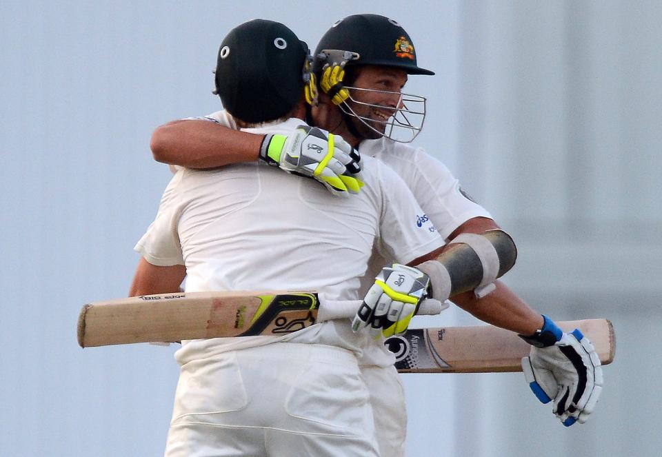 Australian cricketers Ryan Harris (back) and Ben Hilfenhaus (R) celebrate after taking the last run to win during the final day of the first-of-three Test matches between Australia and West Indies at the Kensington Oval stadium in Bridgetown on April 11, 2012. Australia defeated West Indies by 3 wickets. AFP PHOTO/Jewel Samad (Photo credit should read JEWEL SAMAD/AFP/Getty Images)