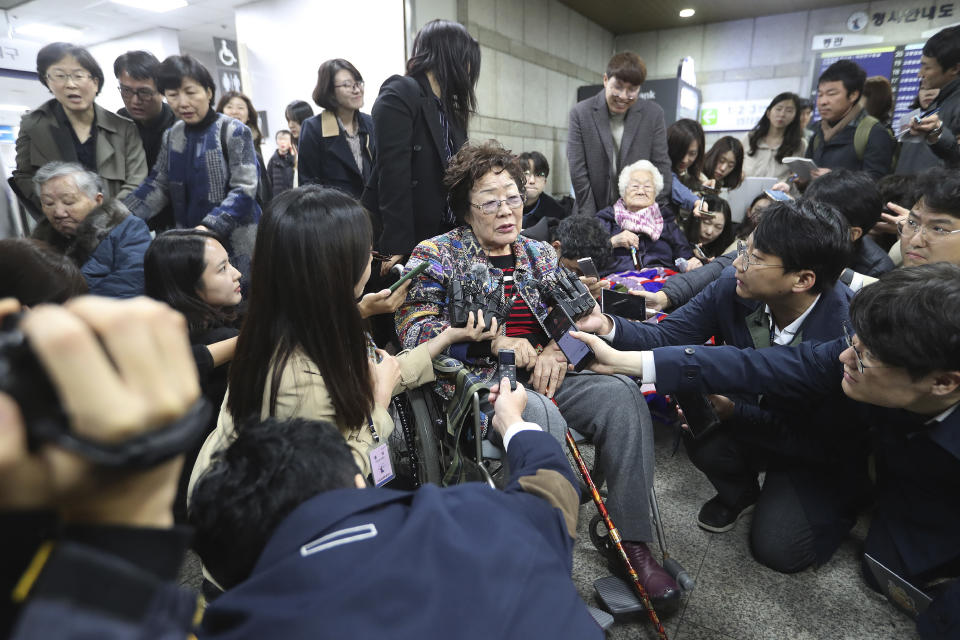 Former South Korean comfort woman Lee Yong-soo, center, speaks before leaving the Seoul Central District Court in Seoul, South Korea, Wednesday, Nov. 13, 2019. A Seoul court on Wednesday began hearing a long-awaited civil case filed against the Japanese government by South Korean women who were forced to work in Japan's World War II military brothels. (AP Photo/Ahn Young-joon)