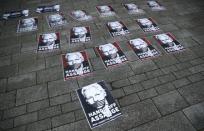 Placards depicting Julian Assange are seen outside of Westminster Magistrates Court, where a case hearing for U.S. extradition of Wikileaks founder Julian Assange is held, in London