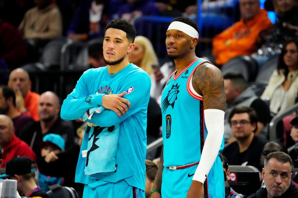 Phoenix Suns guard Devin Booker (1) and forward Torrey Craig (0) prepare to enter the game against the Los Angeles Lakers in the second half at Footprint Center on Nov. 22, 2022.