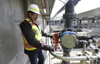 In this March 16, 2017 photo, Robert Waddle, division operations manager at the West Point Treatment Plant in Seattle, stands near a closed valve next to empty pools normally used to remove grit and other solids from sewage and storm water. The plant is still recovering from an equipment failure that crippled operations and caused millions of gallons of raw sewage and untreated runoff to pour into the United States' second largest estuary. (AP Photo/Ted S. Warren)