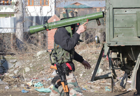 An Indian Army soldier carries a rocket launcher near the site of a gun battle between suspected militants and Indian security forces in Pinglan village in south Kashmir's Pulwama district February 18, 2019. REUTERS/Younis Khaliq