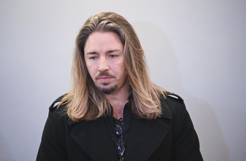 German rock musician Gil Ofarim stands in the courtroom of the district court in Leipzig, Germany, Tuesday, Nov. 28, 2023. A German-Israeli singer who claimed he had been turned away from a hotel in the eastern German city of Leipzig because he was wearing a Star of David pendant, admitted during a defamation trial against him over the incident on Tuesday that he had made up the story. (Hendrik Schmidt/dpa via AP)