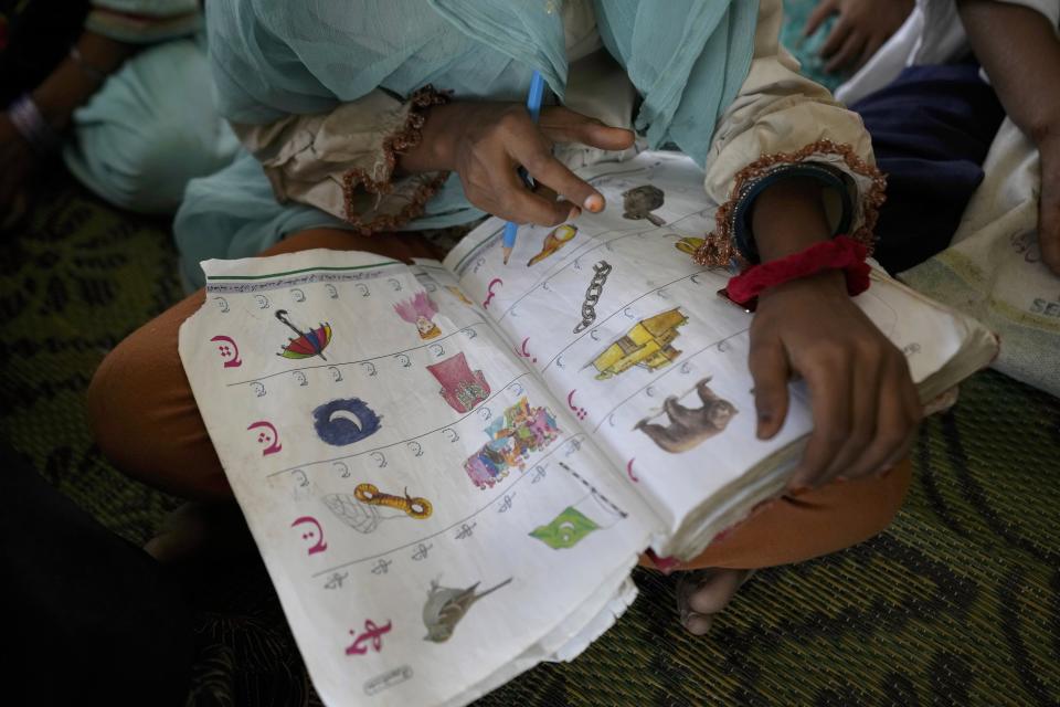 A girl attends a school set up in a tent in Arzi Naich village in Dada, a district of Pakistan's Sindh province, Wednesday, May 17, 2023. Many children are still without schools as authorities struggle to repair the extensive damage. (AP Photo/Anjum Naveed)