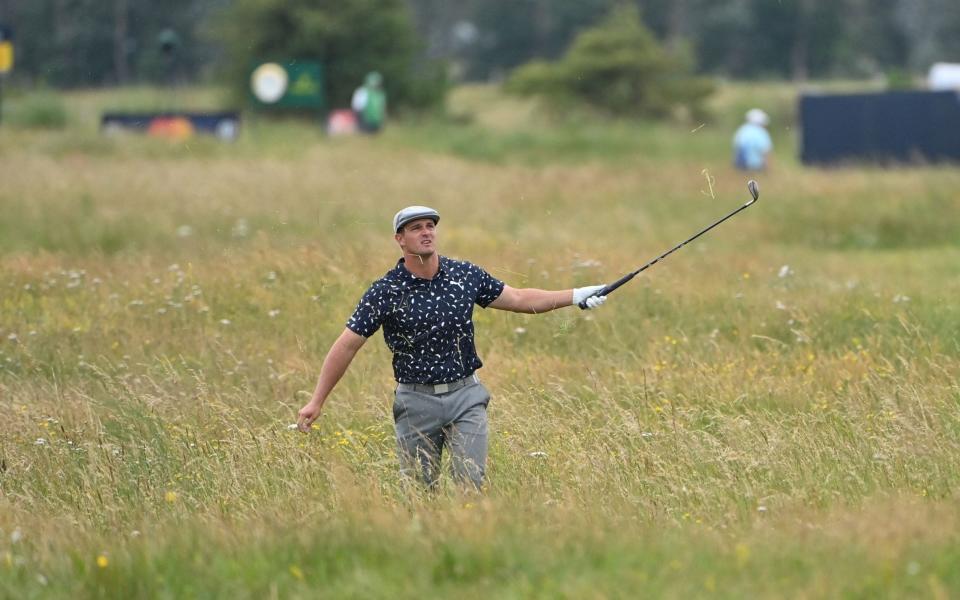 US golfer Bryson DeChambeau gestures from the deep rough on the 15th hole during his first round on day one of The 149th British Open Golf Championship at Royal St George's, Sandwich in south-east England on July 15, 2021. - GETTY IMAGES